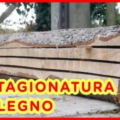 Tavole di legno grezzo impilate, pronte per la stagionatura. Il processo di stagionatura del legno è fondamentale per la sua durabilità.