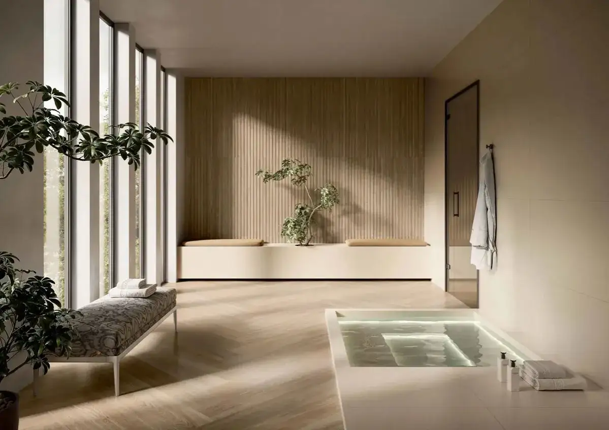 Bagno moderno con vasca illuminata, panca imbottita e piante, in un elegante stile minimal.